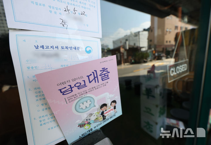 [서울=뉴시스] 김명년 기자 = 지난 5월 22일 오후 서울 시내 한 음식점에 납세고지서 도착 안내문과 대출 전단지가 붙어 있다. 2025.06.19. kmn@newsis.com