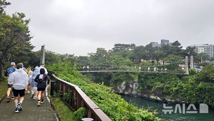 [제주=뉴시스] 임재영 기자 = 제주국제울트라마라톤대회 참가 선수들이 24일 오전 제주시 용연 구름다리를 지나고 있다. 이들은 50㎞, 100㎞, 200㎞ 등 3개 종목에서 자신의 한계에 도전하는 경기를 펼친다. 2025.05.26. ijy788@newsis.com