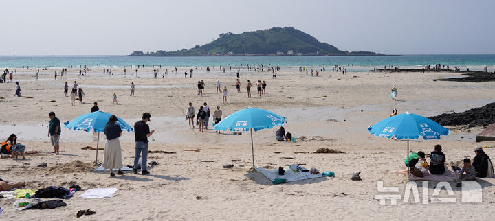 [제주=뉴시스] 우장호 기자 = 맑은 날씨를 보인 25일 오후 제주시 한림읍 협재해수욕장을 찾은 관광객들이 때 이른 여름 정취를 만끽하고 있다. 2025.05.25. woo1223@newsis.com