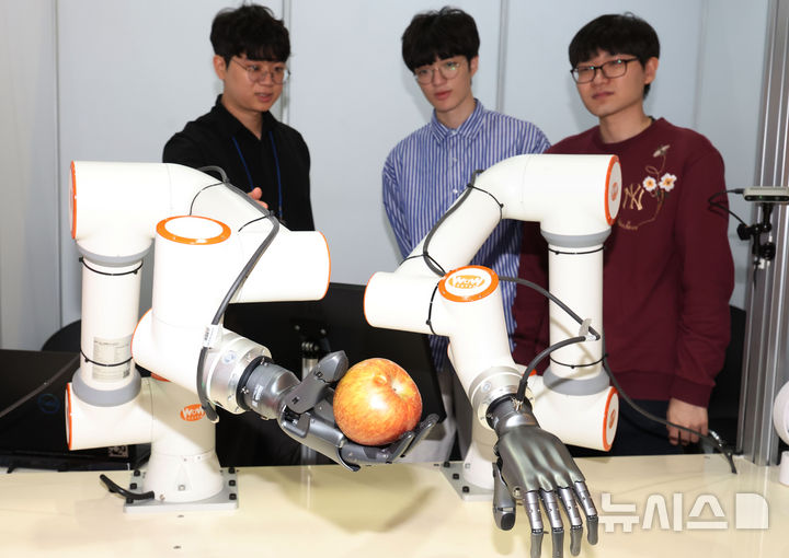 [서울=뉴시스] 조수정 기자 = 지난 5월 26일 서울 강남구 코엑스에서 열린 2025 제1차 KB굿잡 우수기업 취업박람회에서 취업준비생들이 한국폴리텍대학교의 자율 인공지능 로봇팔 체험 시연을 보고 있다. 2025.05.26. chocrystal@newsis.com