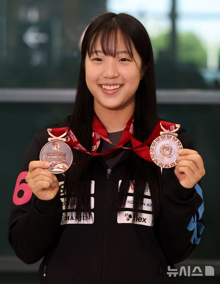 [인천공항=뉴시스] 추상철 기자 = 2025 국제탁구연맹(ITTF) 세계선수권대회에서 동메달 2개를 획득한 신유빈이 26일 오후 인천국제공항 제1터미널을 통해 귀국한 후 메달을 들어 보이고 있다. 025.05.26. scchoo@newsis.com