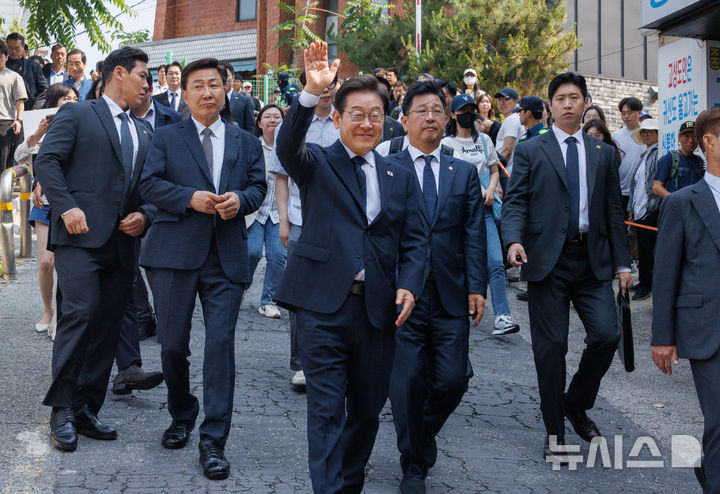 [서울=뉴시스] 조성우 기자 = 이재명 더불어민주당 대선후보가 제21대 대통령 선거 사전투표 첫날인 29일 서울 서대문구 신촌동 주민센터 투표소에서 사전투표를 마치고 나와 손을 들어 시민들에게 인사하고 있다. (공동취재) 2025.05.29. photo@newsis.com