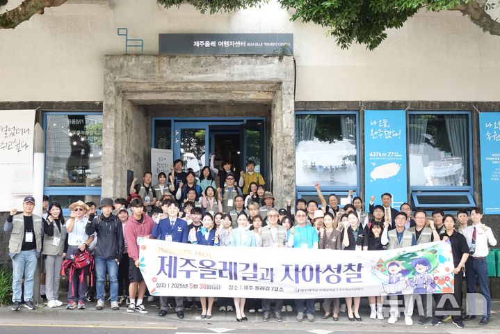 [제주=뉴시스] 양영전 기자 = 30일 오전 서귀포시 서귀동 제주올레여행자센터 앞에서 제주대 '제주올레길과 자아성찰' 수업 참가자들이 기념 촬영을 하고 있다. 2025.05.30. 0jeoni@newsis.com