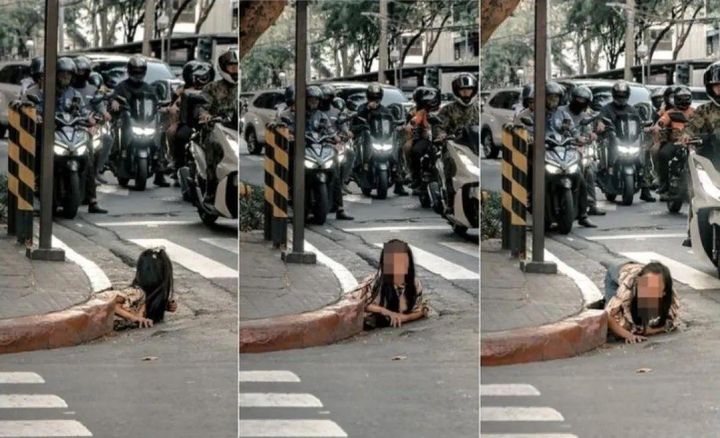 [서울=뉴시스]한 젊은 여성이 거리 한쪽의 배수구에서 기어나오는 모습이 포착돼 화제다.(사진=광명왕) *재판매 및 DB 금지