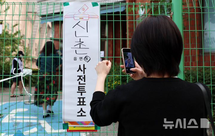 [서울=뉴시스] 이영환 기자 = 한 유권자가 제21대 대통령 선거 사전투표 이틀째인 30일 오전 서울 서대문구 구 신촌동주민센터에 마련된 사전투표소에서 투표를 마친 후 인증샷을 촬영하고 있다. 2025.05.30. 20hwan@newsis.com