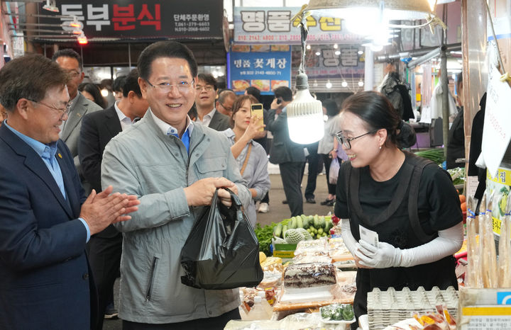 [목포=뉴시스] 송창헌 기자 = 김영록 전남지사가 4일 오전 목포 동부시장을 방문, 제21대 대통령 선거 투표에 참여해준 도민께 감사 인사를 하며 물건을 구입하고 있다. (사진=전남도 제공) 2025.06.04 photo@newsis.com&nbsp; *재판매 및 DB 금지