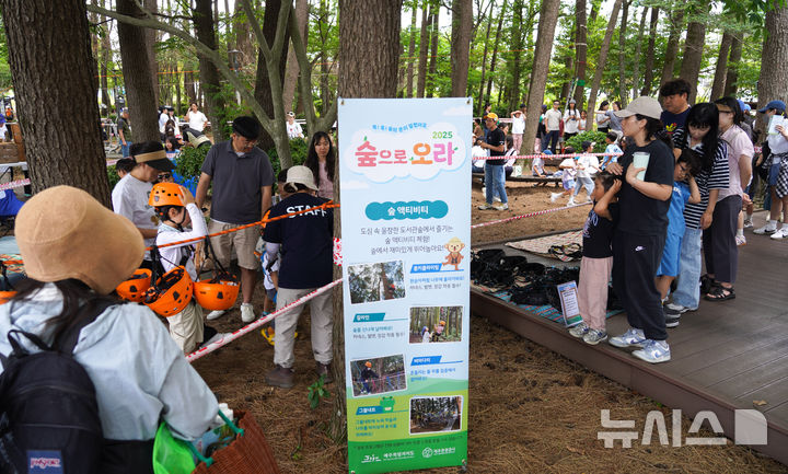 [제주=뉴시스] 우장호 기자 = 6일 제주시 한라도서관 일대에서 열린 생태체험 축제 '2025 숲으로 오라'에서 부모님과 행사장을 찾은 어린이들이 숲액티비티를 체험하고 있다. 8일까지 사흘간 열리는 '숲으로 오라' 축제는 제주관광공사가 2019년부터 매년 어린이를 비롯해 동반 가족을 대상으로 자연의 가치와 환경의 중요성을 알리기 위해 여는 참여행 생태체험 행사다. 2025.06.06. woo1223@newsis.com