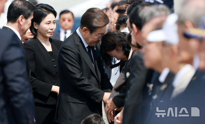 [서울=뉴시스] 고범준 기자 = 이재명 대통령이 6일 서울 동작구 국립서울현충원에서 열린 제70회 현충일 추념식에 입장하며 한 유족을 위로하고 있다. 2025.06.06. bjko@newsis.com