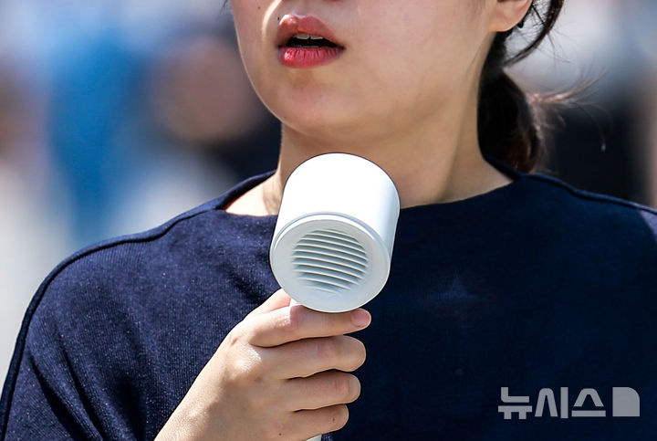 [서울=뉴시스] 정병혁 기자 = 더운 날씨를 보인 9일 서울 강남구 코엑스 인근에서 한 시민이 손선풍기를 들고 이동하고 있다. 2025.06.09. jhope@newsis.com