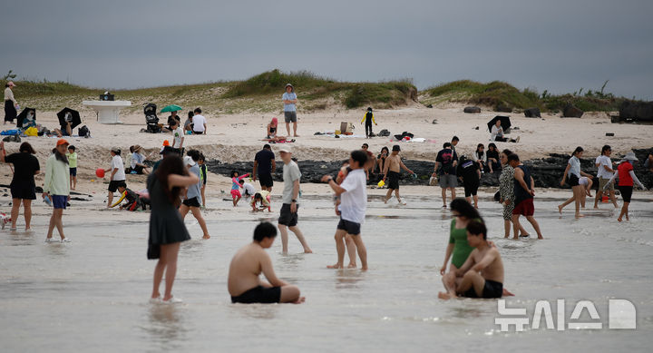 [제주=뉴시스] 우장호 기자 = 정체전선이 잠시 소강상태를 보인 15일 오후 제주시 한림읍 협재해수욕장을 찾은 관광객들이 물놀이를 하며 한낮 더위를 식히고 있다. 2025.06.15. woo1223@newsis.com
