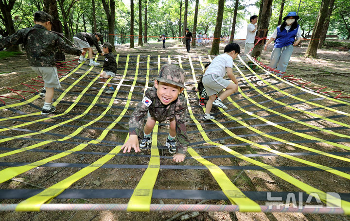 [대구=뉴시스] 이무열 기자 = 18일 대구 북구 옻골공원에서 한국자유총연맹 대구북구지회 주최로 열린 ‘6.25전쟁 당시 음식 재현 시식회 및 어린이 병영 숲 체험전 및 어린이 병영 체험전’에 참가한 어린이들이 군복을 입고 병영체험을 하고 있다. 2025.06.18. lmy@newsis.com
