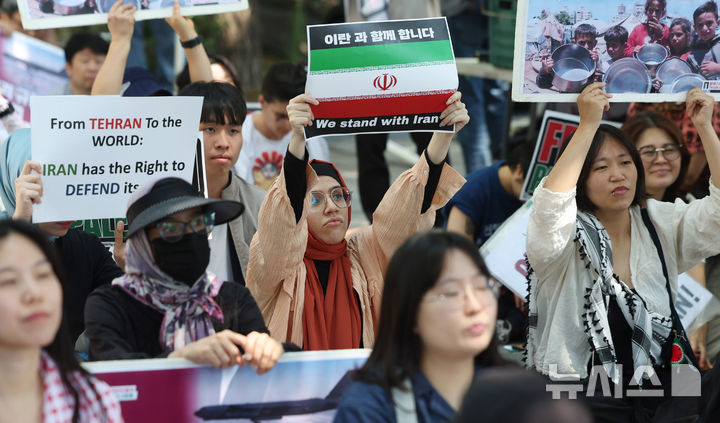 [서울=뉴시스] 추상철 기자 = 트럼프 미국 대통령이 이란의 주요 핵 시설을 파괴했다고 밝힌 22일 오후 서울 종로구 교보빌딩 인근에서 열린 노동자연대의 '전쟁 중단 및 이스라엘 공격 규탄집회'에서 이란인 등 집회 참가자가 피켓을 들고 전쟁 중단을 촉구하고 있다. 2025.06.22. scchoo@newsis.com