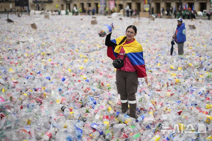 [보고타=AP/뉴시스] 24일(현지 시간) 콜롬비아 보고타의 볼리바르 광장에서 재활용품 수거 종사자들이 플라스틱병을 광장에 깔아 놓고, 재활용품 매입 업체들의 매입가가 지나치게 낮다며 항의 시위를 벌이고 있다. 2025.06.25.