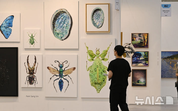 [수원=뉴시스] 김종택 기자 = 26일 경기 수원시 영통구 수원컨벤션센터에서 열린 '2025 화랑미술제 in 수원'을 찾은 관람객들이 전시된 작품을 감상하고 있다. 가나아트, 학고재 등 협회 소속 국내 104개 갤러리가 참여한 이번 전시회는 약 600여 명의 작가들이 작품을 출품했다. 2025.06.26. jtk@newsis.com