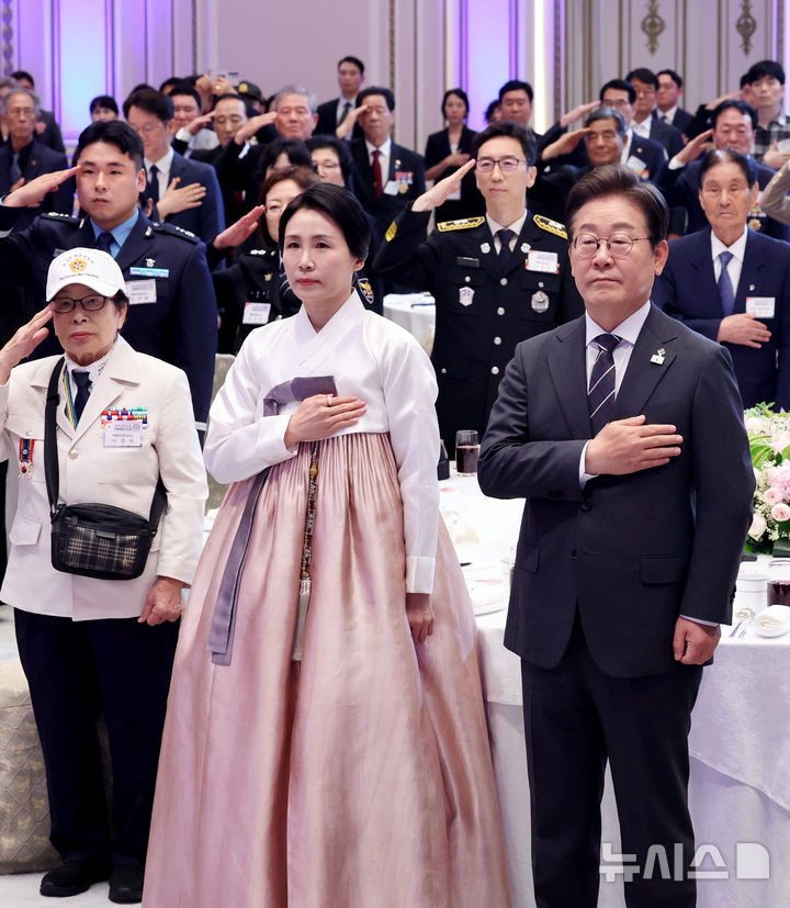 [서울=뉴시스] 최진석 기자 = 이재명 대통령과 부인 김혜경 여사가 27일 청와대 영빈관에서 열린 '호국보훈의 달, 대통령의 초대' 행사에서 국기에 경례하고 있다. (대통령실통신사진기자단) 2025.06.27. myjs@newsis.com
