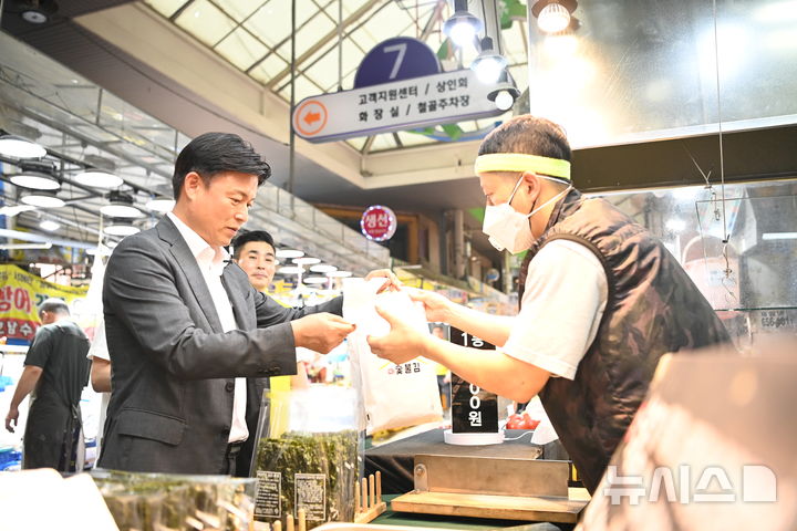 [부천=뉴시스] 조용익 경기 부천시장이 30일 상동시장을 방문해 민생경제를 현장에서 살피고 부천페이로 장을 보고 있다. (사진=부천시 제공) 2025.06.30. photo@newsis.com 