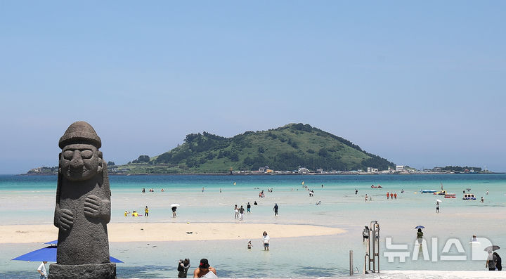 [제주=뉴시스] 우장호 기자 = 3일 오후 제주시 한림읍 금능해수욕장을 찾은 피서객들이 바닷물에 발을 담그며 더위를 식히고 있다. 2025.07.03. woo1223@newsis.com