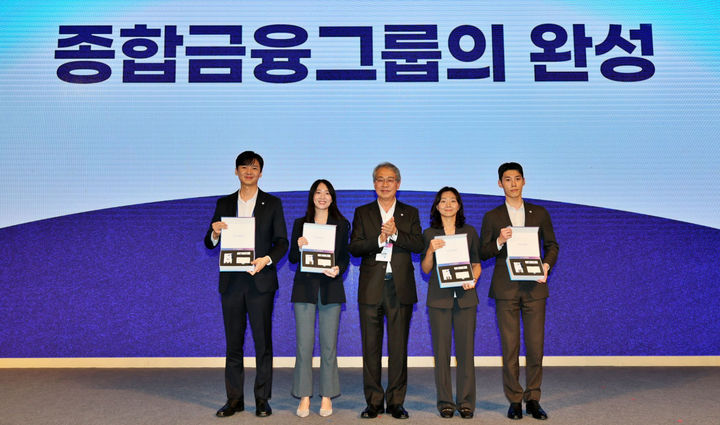 11일 서울 용산 드래곤시티에서 열린 '우리 WON Day' 행사에 참석한 임종룡 우리금융회장(가운데)이 동양·ABL생명 직원 대표 4명에게 그룹 사원증, 명함, 휘장이 담긴 비즈니스 키트를 수여하고 있다. (사진=우리금융 제공) *재판매 및 DB 금지