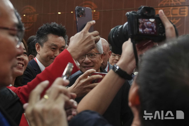 [베이징=AP/뉴시스] 젠슨 황 엔비디아 최고경영자(CEO)가 16일(현지 시간) 중국 베이징에서 열린 제3회 중국 국제 공급망 촉진 박람회 개막식에서 참석자들로부터 셀카 요청을 받고 있다. 2025.07.16.