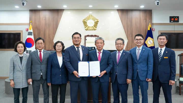 [괴산=뉴시스] 16일 충북 괴산군의회 본회의장에서 군의원들이 지역사랑상품권 사용범위 확대 건의문을 채택한 뒤 기념사진을 찍고 있다. (사진=괴산군의회 제공) 2025.7.16. photo@newsis.com *재판매 및 DB 금지