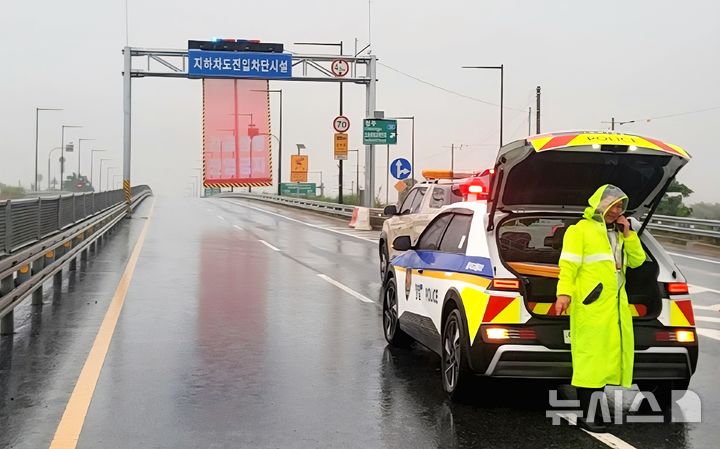 [청주=뉴시스] 17일 충북 청주시 흥덕구 오송읍 궁평2지하차도가 인근 미호강교 지점에 대한 홍수 경보 발령에 따라 통제된 가운데 현장에 출동한 경찰관이 주변을 살피고 있다.(사진=충북도 제공) 2025.07.17. photo@newsis.com *재판매 및 DB 금지