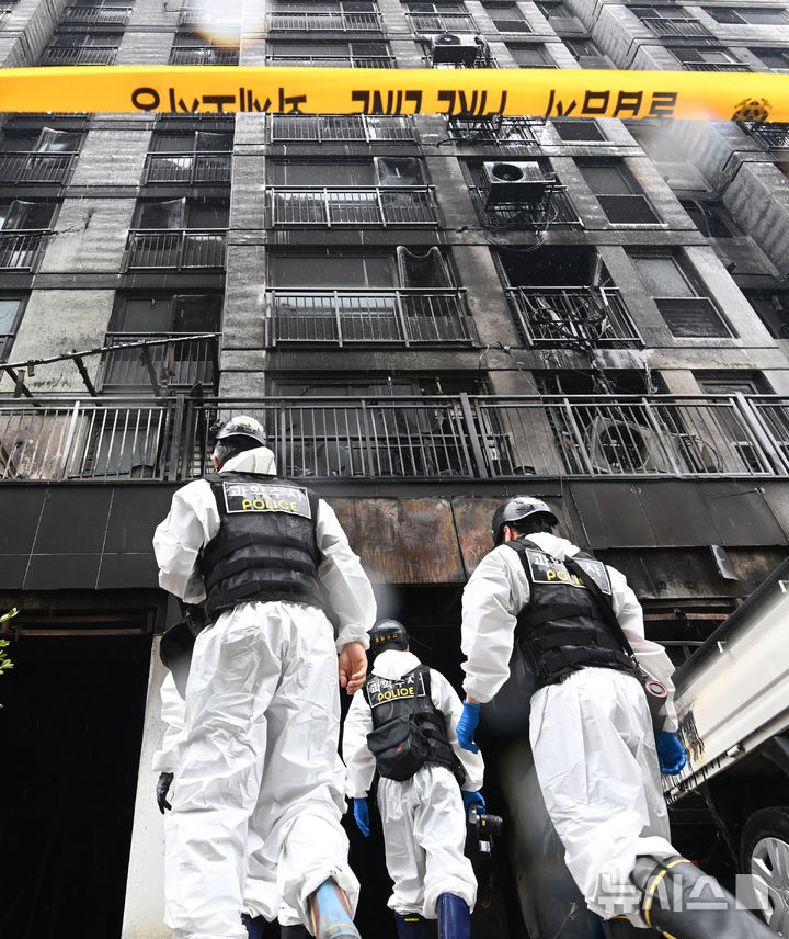 [광명=뉴시스] 김종택 기자 = 경찰과 소방 및 국립과학수사연구원 등 관계자들이 18일 경기 광명시 아파트에서 합동감식을 위해 화재현장으로 이동하고 있다. 앞서 지난 17일 오후 9시5분께 이 아파트 주차장 필로티 천장에서 불이나 1명이 숨지고 64명이 부상을 입었다. 2025.07.18. jtk@newsis.com