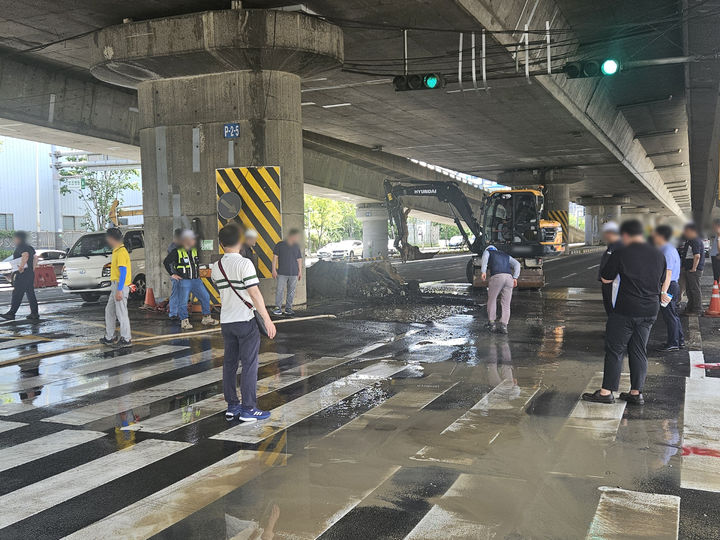 [부산=뉴시스] 21일 오후 부산 사상구 새벽시장 앞 도로에서 누수가 발생해 원인 파악을 위한 굴착 작업이 진행되고 있다. (사진=부산경찰청 제공) 2025.07.21. photo@newsis.com *재판매 및 DB 금지