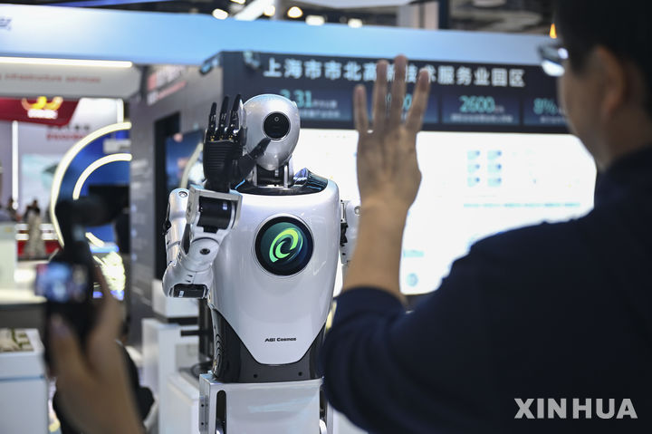 [상하이=신화/뉴시스] 지난 26일 중국 상하이에서 열린 국제 인공지능(AI) 콘퍼런스 및 글로벌 AI 거버넌스 고위급 회의 전시장에서 방문객이 휴머노이드 로봇과 상호작용하고 있다. 2025.07.27.