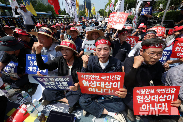 [서울=뉴시스] 조성우 기자 = 28일 오후 서울 용산구 대통령 인근에서 열린 한-미 상호관세 협상 농축산물 개방 반대 전국농축산인 결의대회에서 한국농축산연합회와 한국종합농업단체협의회, 축산관련단체협의회, 농민의 길 등 농민단체 소속 단체장들과 농민들이 구호를 외치고 있다. 2025.07.28. xconfind@newsis.com