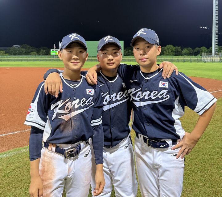[서울=뉴시스] 한국 12세 이하(U-12) 야구대표팀 하정우(왼쪽부터), 이재승, 홍성현이 28일(한국 시간) 대만 타이난에서 열린 제8회 세계유소년야구선수권대회 B조 예선 4차전 승리 후 기념 사진을 찍고 있다. (사진=대한야구소프트볼협회 제공) 2025.07.28. *재판매 및 DB 금지