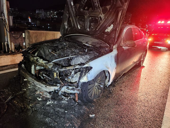 [부산=뉴시스] 29일 오후 부산 사상구 관문대로를 달리던 트레일러 차량이 방호벽과 중앙분리대, 가로등을 잇달아 들이받았다. 사고 충격으로 반대편 차로로 넘어간 가로등 파편을 밟고 지나간 승용차에서 불이 났다. (사진=부산소방재난본부 제공) 2025.07.30. photo@newsis.com *재판매 및 DB 금지