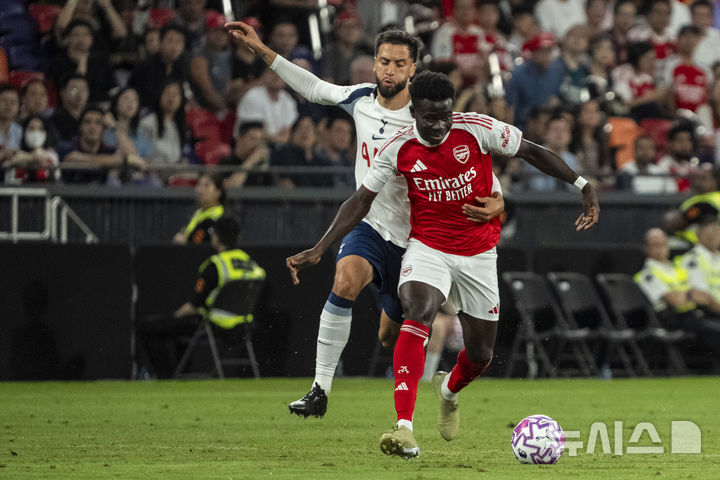 [홍콩=AP/뉴시스] 잉글랜드 프로축구 프리미어리그(EPL) 아스널의 부카요 사카와 토트넘의 로드리고 벤탕쿠르. 2025.07.31.