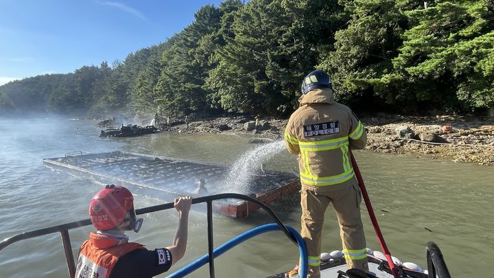 [거제=뉴시스] 신정철 기자= 통영해양경찰서는 31일 오후 4시 33분께 경남 거제시 남부면 탑포항에 정박 계류중인 선박에서 화재가 발생, 어선 2척이 전소되고 어선 1척과 바지선 2척이 불탔다.사진은 통영해경 구조대원이 불타는 바지선 진화작업을 펼치고 있는 모습.(사진=통영해경 제공).2025.07.31. photo@newsis.com *재판매 및 DB 금지