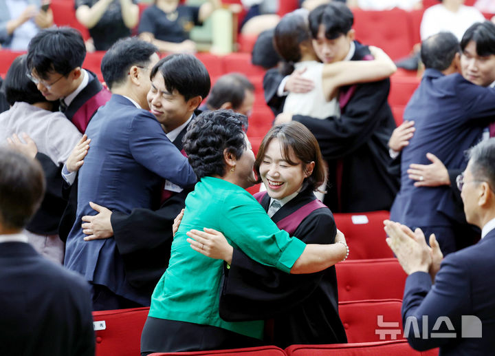 [과천=뉴시스] 김진아 기자 = 1일 경기 정부과천청사 법무부에서 열린 2025 하반기 신임검사 임관식에서 신임 검사들이 부모님과 포옹을 하고 있다. 2025.08.01. bluesoda@newsis.com