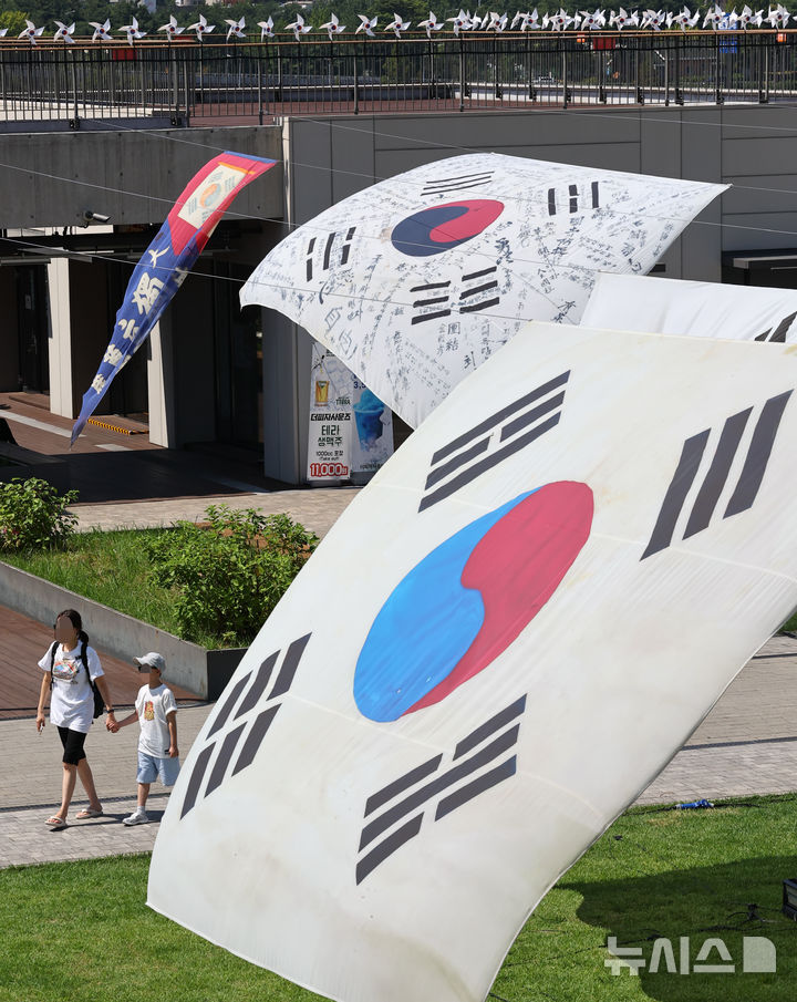 [서울=뉴시스] 최진석 기자 = 광복 80주년을 앞둔 10일 서울 노들섬에 역사 속의 태극기가 전시되어 있다. 노들 야외스퀘어에서는 현존하는 가장 오래된 ‘데니 태극기’부터 일제강점기, 광복 이후의 태극기까지 시대별 변화를 보여주는 16점의 대형 태극기가 한반도 형상 위에 전시된다. 2025.08.10. myjs@newsis.com