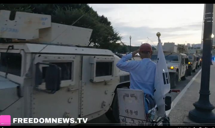 [워싱턴=뉴시스]미국 독립언론인 프리덤뉴스TV는 트럼프 대통령 지시에 따라 워싱턴DC 주방위군의 시내 배치가 시작된 지난 12일(현지 시간) 공개한 영상으로, 워싱턴기념탑 인근에서 군인들을 태운 장갑차가 지나가자 태극기를 지참한 시민이 경례를 하고 있는 모습. (사진=프리덤뉴스TV 영상 캡쳐).2025.08.15. *재판매 및 DB 금지