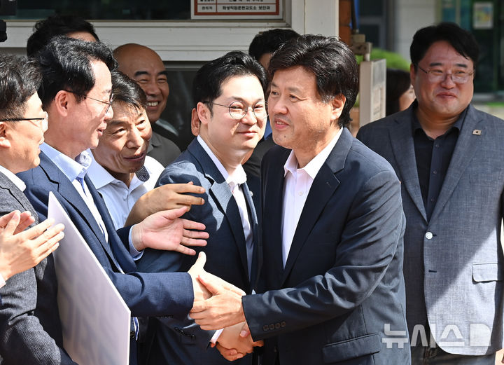 [화성=뉴시스] 김종택 기자 = 정치자금법위반·특정범죄 가중처벌법상 뇌물 혐의로 기소된 김용 전 민주연구원 부원장이 20일 경기 화성시 마도면 화성직업훈련교도소에서 보석으로 석방돼 지지자들에게 인사하고 있다. 2025.08.20. jtk@newsis.com