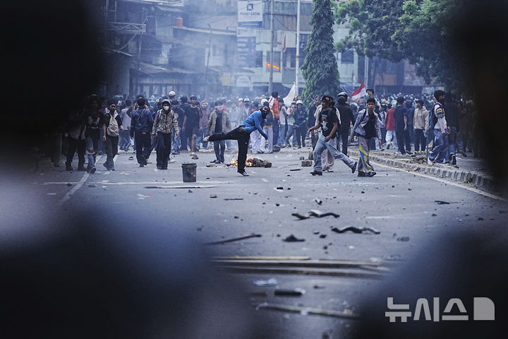 [자카르타=AP/뉴시스] 인도네시아 자카르타에서 시위대가 국회의원에게 주어지는 사치스러운 수당에 항의하며 진압 경찰을 향해 돌을 던지고 있다. 2025.08.25