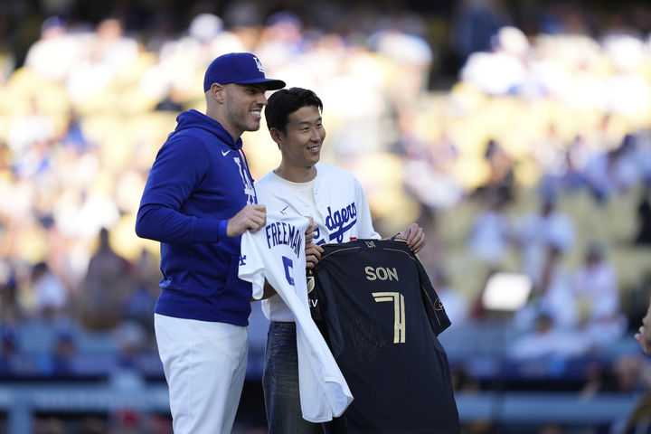 [로스앤젤레스=AP/뉴시스] 미국 메이저리그사커(MLS) 로스앤젤레스(LA) FC의 손흥민(오른쪽)이 지난 27일(현지 시간) 캘리포니아주 로스앤젤레스의 다저 스타디움에서 열리는 2025 메이저리그 LA 다저스와 신시내티 레즈의 경기에서 시구하기 전 다저스 1루수 프레디 프리먼과 유니폼을 교환하고 있다. 2025.08.28.