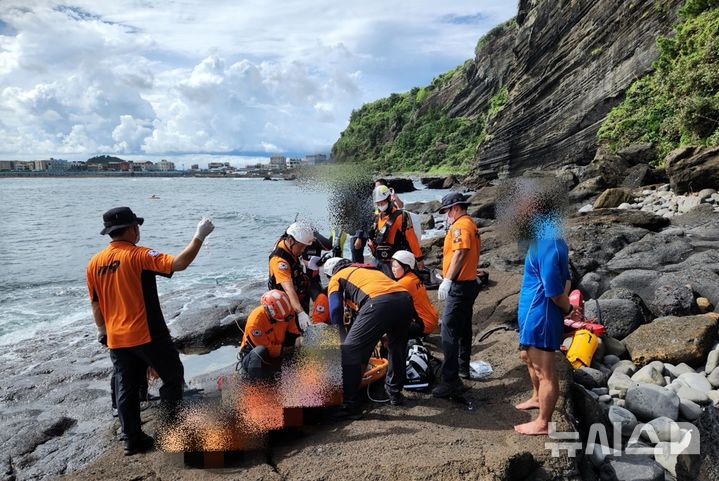 [서귀포=뉴시스] 31일 오후 제주 서귀포시 성산일출봉 서쪽 해변에서 60대 남성 A씨가 스노클링 중 의식을 잃었다는 신고가 119에 접수됐다. 현장에 출동한 119구조대가 응급처치를 하고 있다. (사진=제주소방안전본부 제공) 2025.08.31. photo@newsis.com *재판매 및 DB 금지