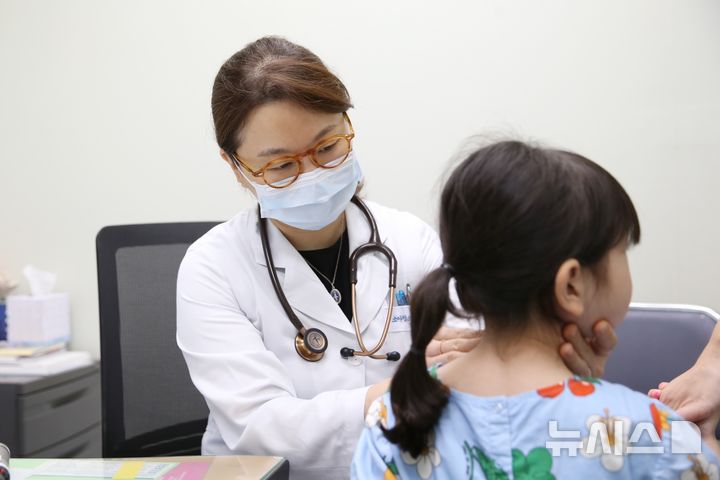 [서울=뉴시스] 김혜리 서울아산병원 소아청소년종양혈액과 교수(왼쪽)가 소아급성림프모구백혈병 환아를 진료하고 있다. (사진= 서울아산병원 제공)