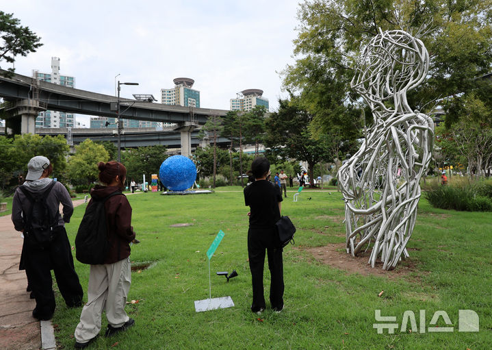 [서울=뉴시스] 이영환 기자 = 1일 서울 광진구 뚝섬한강공원에서 열린 제2회 서울조각페스티벌을 찾은 시민들이 전시된 조각을 살펴보고 있다. 2025.09.01. 20hwan@newsis.com