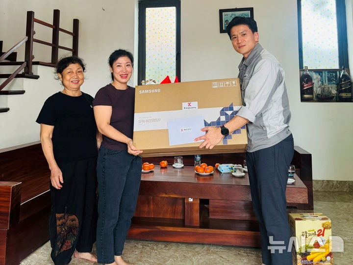 [창원=뉴시스] 경남 창원시 진해구 케이조선 노사협력팀 신동규(오른쪽) 팀장이 베트남을 방문해 외국인 근로자 가족에게 선풍기를 전달하고 있다. (사진=케이조선 제공) 2025.09.02. photo@newsis.com