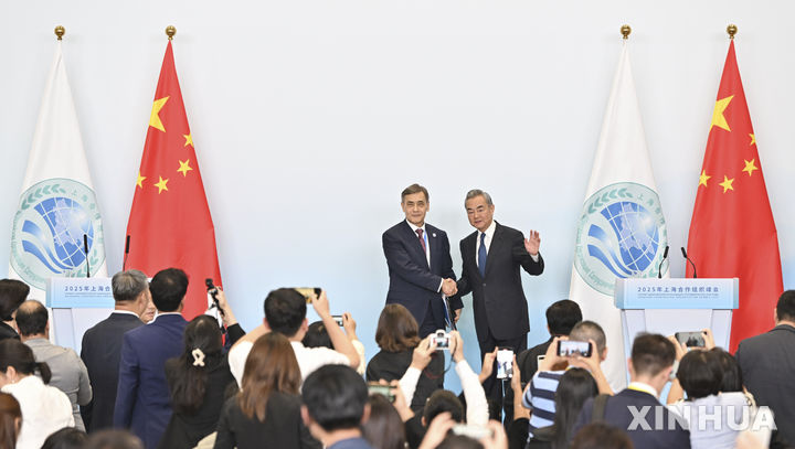 [톈진=신화/뉴시스] 왕이 중국 외교부장(오른쪽)이 1일 톈진에서 상하이협력기구(SCO) 눌란 예르메크바예프 사무총장과 만나 악수하고 있다. 2025.09.02. 