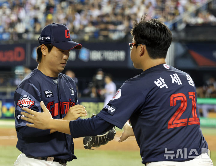 [서울=뉴시스] 배훈식 기자 = 2일 오후 서울 송파구 잠실야구장에서 열린 2025 신한 쏠뱅크 KBO리그 LG 트윈스와 롯데 자이언츠의 경기, 7회말 2사 3루 위기를 잘 틀어막은 롯데 구원투수 정현수와 선발 박세웅이 하이파이브를 하고 있다. 2025.09.02. dahora83@newsis.com