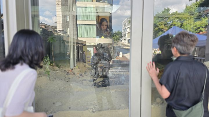 [사진=박현주 미술전문기자' 전시장 입구에 어떤 안내 표식도 없어, 밖에서 유리창 너머를 호기심 어린 눈빛으로 들여다보는 관객들의 모습. *재판매 및 DB 금지