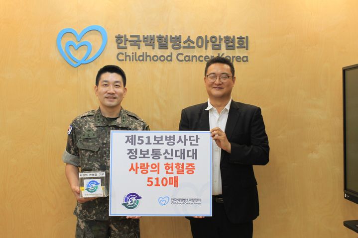 [화성=뉴시스]이성호 육군 제51보병사단 정보통신대대장(사진 왼쪽)이 4일 서울 마포구 한국백혈병소아암협회에서 전호철 기획국장에게 헌혈증서를 전달한 후 함께 기념촬영을 하고 있다.(사진=육군 제51보병사단 제공)2025.09.04.photo@newsis.com *재판매 및 DB 금지