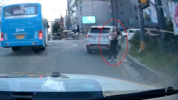 열경련으로 의식을 잃은 아이를 안고 순찰차에 다가오는 시민 모습. (사진=경기남부경찰청 제공) *재판매 및 DB 금지