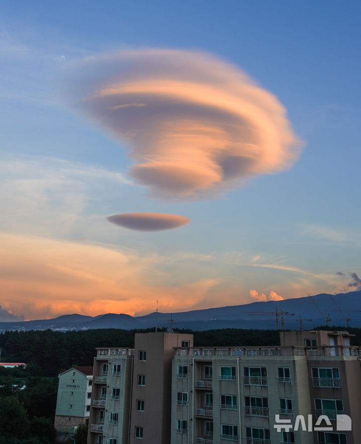 [제주=뉴시스] 우장호 기자 = 온종일 내린 비가 그치고 맑게 갠 13일 오후 제주시 오라동에서 바라본 남동쪽 하늘에 렌즈구름이 떠올라 시선을 사로 잡고 있다. 일명 'UFO'구름으로 불리는 렌즈구름은 한라산을 넘어 온 덥고 습한 남서풍이 제주도의 지형과 만나 생기는 것으로 알려져 있다. 2025.09.13. woo1223@newsis.com