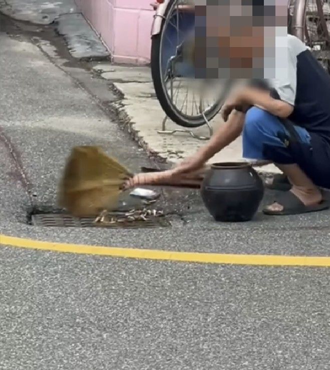 [서울=뉴시스] 군산에서 한 노인이 도로 빗물받이에 담배꽁초와 쓰레기를 버리는 모습이 포착돼 논란이 일고 있다. (사진=온라인 커뮤니티 캡처) 2025.09.17 *재판매 및 DB 금지